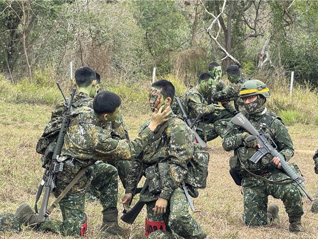 训员彼此帮忙，在脸上画上偽装。（李奇叡摄）