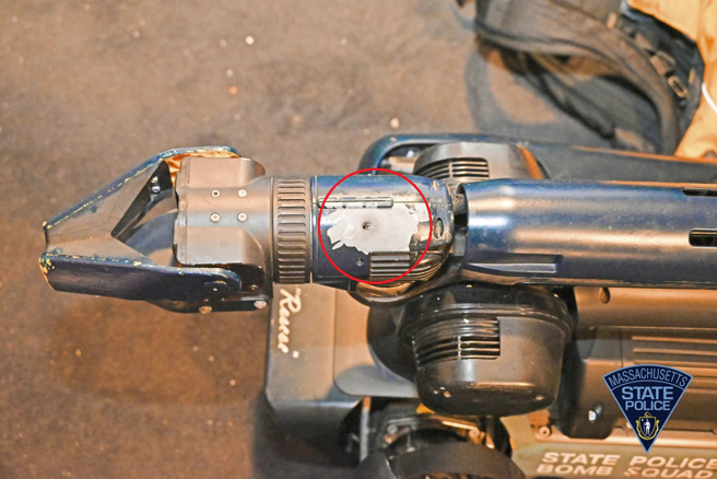 名为Roscoe的机器狗，在枪战中被击中3次，红圈中是其中一个弹孔。(图/美联社)