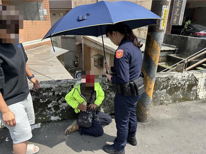 野柳派出所警員黃郁珊協助倒地的吳姓老翁。（金山警分局提供）