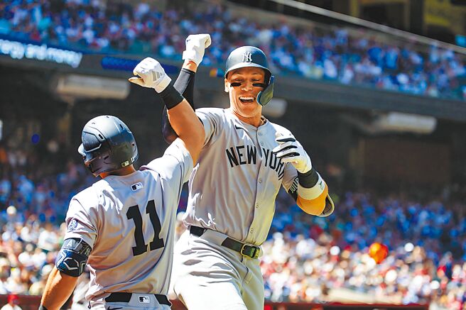 洋基重炮賈吉（右）首轟出爐後回到本壘與隊友慶祝。（路透）