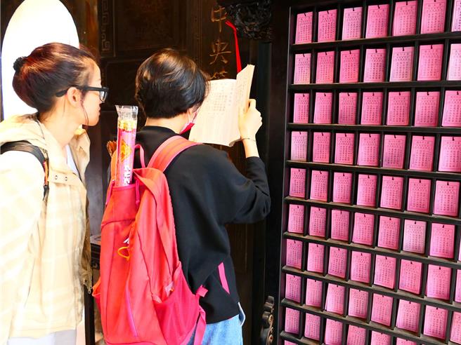 云林县北港镇武德宫财神庙求籤者愈来愈多，以往信眾都是翻阅解籤簿自行推敲（见图），或请解籤人员说明，庙方为方便信眾解籤，设置「解籤辅助机器人」，10日正式启用。（张朝欣摄）