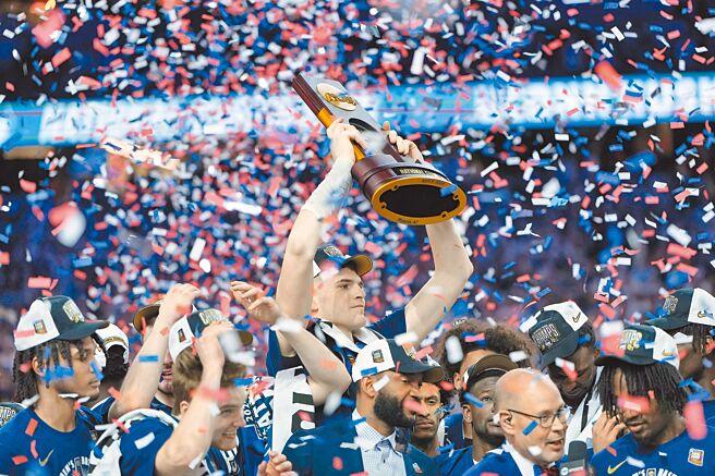 康乃狄克哈士奇隊衛冕成功，中鋒克林根驕傲舉起NCAA冠軍獎盃。（路透）