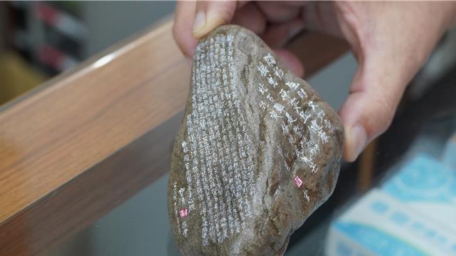 陈宝清以工笔小楷将心经抄在小巧奇石上。（宝智华摄）