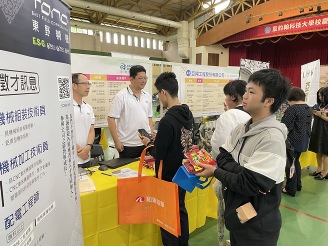 董事會羅文進董事所創辦的易發集團（校友企業）於現場招募新血，同學仔細詢問相關徵才訊息。(照片/聖約翰科技大學)