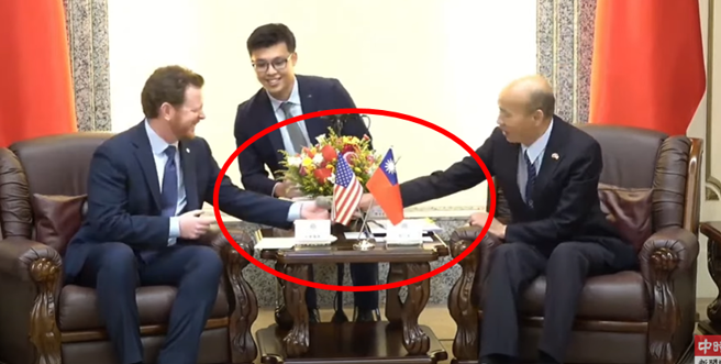 图为韩国瑜发现舒默并没有麦克风时，立刻递上麦克风的画面。（取自中时新闻网影片）