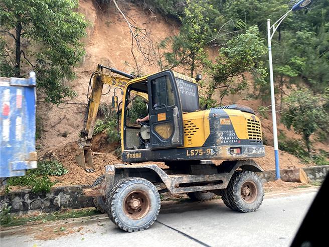 坑殺48條人命後現場，廣東梅大高速坍方前，周邊有滑坡徵兆。圖為2日通往坍方現場的S221省道上，正在清理道路滑坡沙土的施工車輛。（澎湃新聞）