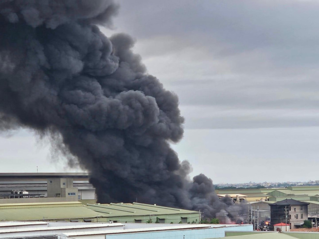 台南建材工厂从昨夜至今晨延烧11小时浓烟窜天，整座厂房陷入火海。(翻摄自记者爆料网)