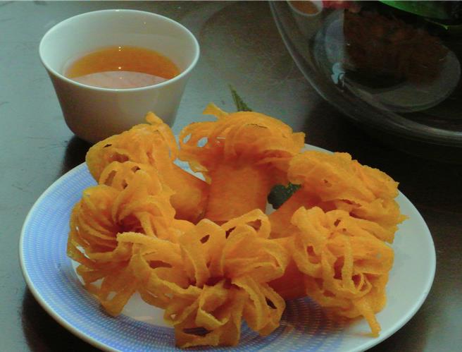 「菊花炸春捲」外皮酥脆，內餡可吃到滿滿蝦漿，乍看頗像一朵朵盛開的大黃菊花，從外觀到風味，都令人記憶猶深，售價220元。(陳韻萍攝)