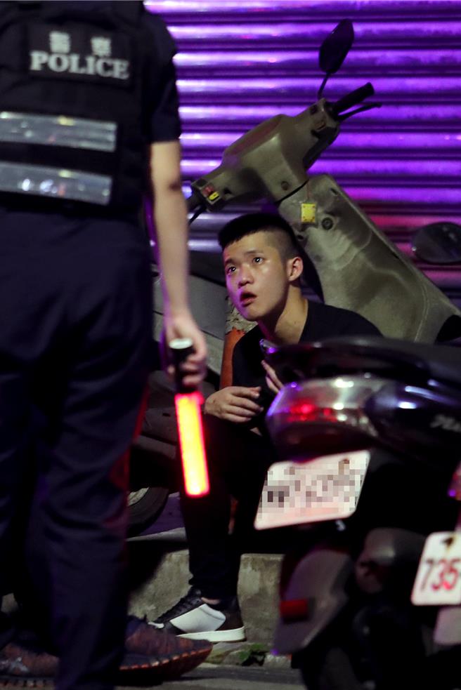 肇事的张男事发后呆坐在路旁。（黄世麒摄）