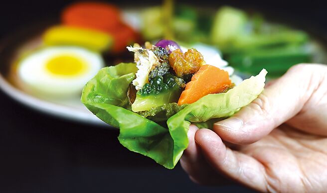 品尝〈香酥鲭鱼鲜蔬蟹膏塔〉时，可以奶油莴苣包卷自己喜欢的蔬食，以及炸鲭鱼肉入馅。图／姚舜