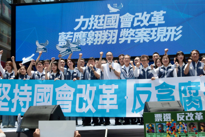 「立法院职权行使法」覆议案21日投票表决结果出炉，绿营不敌蓝白，「覆议案不通过」；国民党主席朱立伦（中）抵达蓝鹰行动现场，偕同党立委上台手牵手欢呼，高呼「反贪腐、查弊案」并呼吁蓝营团结、支持国民党立委。（郭吉铨摄）