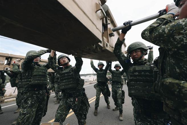  構桁班官兵以4人為一組，合力運用抬棍搬運重達近200公斤的上下構桁完成結構。（記者袁銘駿攝）