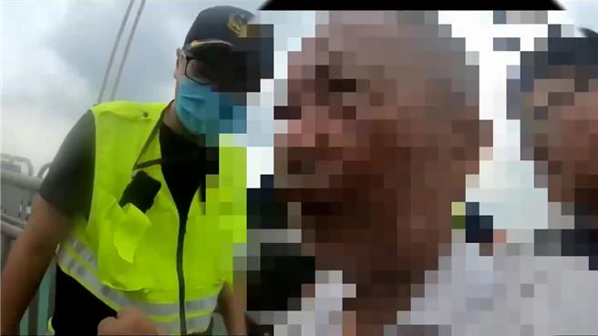 白衣老翁在关渡桥想要轻生，警员在千钧一髮之际将他抱住，从鬼门关救回。（淡水警分局提供）