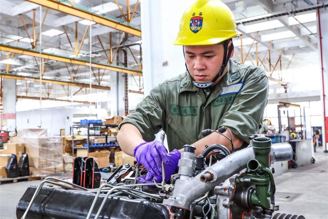 　喷射泵组装完毕，最终确认高压缸管有无锁紧。（记者杨乔琳摄）