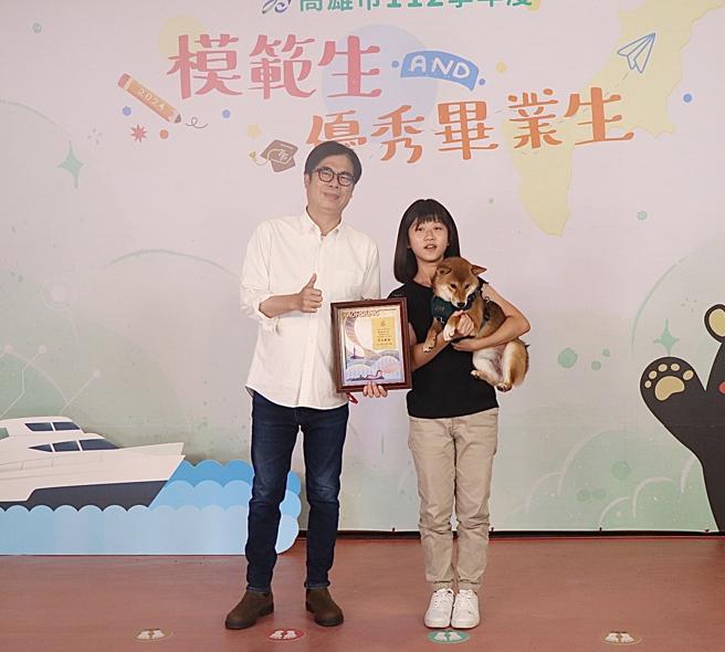 旗山國小張煊翊同學帶著柴犬「貝果」與市長陳其邁合影，一起分享她的榮耀。（圖片來源：高雄市教育局提供）