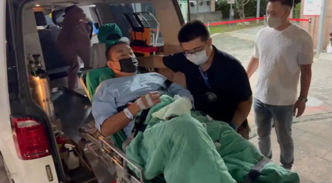 「威震」董座吳明達與司機轉院榮總，現場大批警力在醫院外警戒。畫面為吳明達送上救護車。（圖／翻攝自中天新聞）