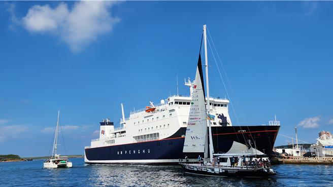 32位小水手接力驾2帆船，逆时针跳岛环台，17日早从澎湖马公亚果游艇港出发，航向望安，图为经过停在马公商港的澎湖轮。（许逸民摄）