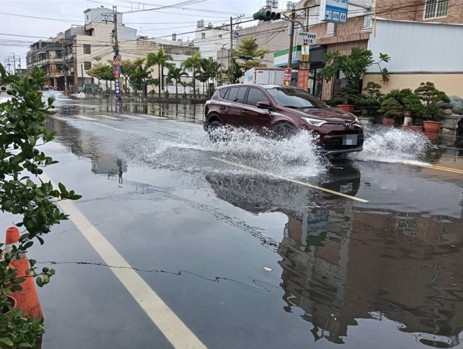 凯米颱风加上年度大潮，东港东津里再度积淹水，汽机车走过，溅起一片水花。（东津里长叶而项提供／罗琦文屏东传真）