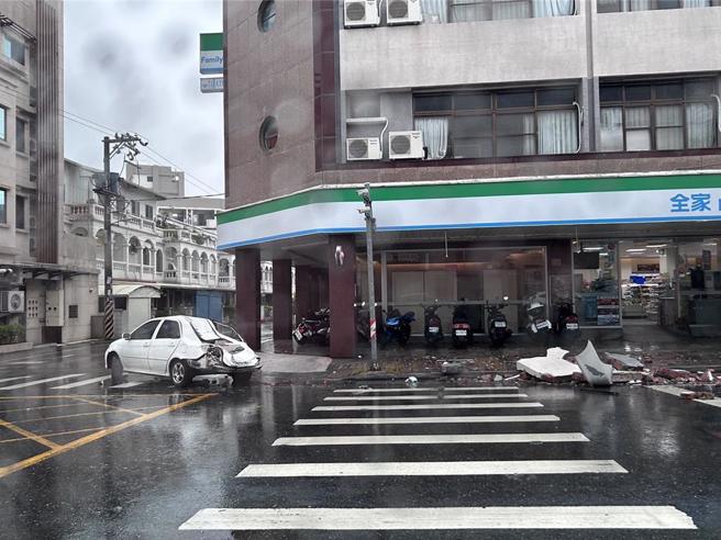 花蓮市中興路1棟5層樓建物女兒牆，疑遭狂風掀起的頂樓鐵皮推倒，停在路邊的轎車後座被砸毀，導致後座母子1死1重傷，遭砸車輛跟磚塊目前仍留在現場。（羅亦晽攝）
