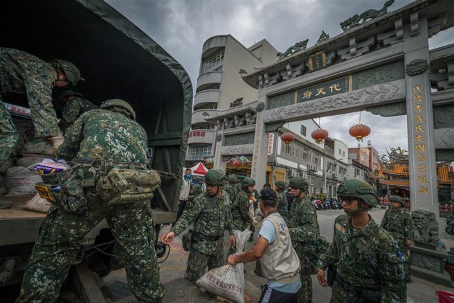 官兵與後輔幹部一同搬運沙包，攜手共護家鄉安全。（記者陳怡璿攝）