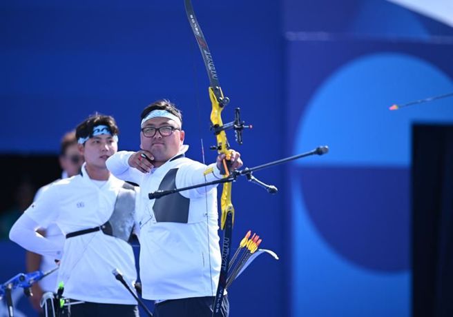 南韩射手金优镇与队友摘下男团金牌。（新华社）