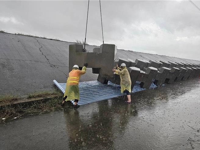 第六河川分署吊消波块镇压六分寮曾文溪堤防掏空处。（郭国文服务处提供／宝智华台南传真）