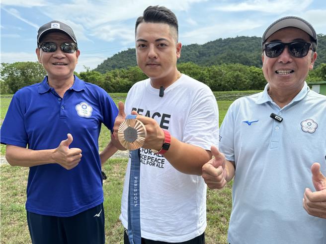 李孟远（中）13日回训练母基地宜兰大同乡四方林靶场，与射击前辈们分享夺牌喜悦。（吴佩蓉摄）