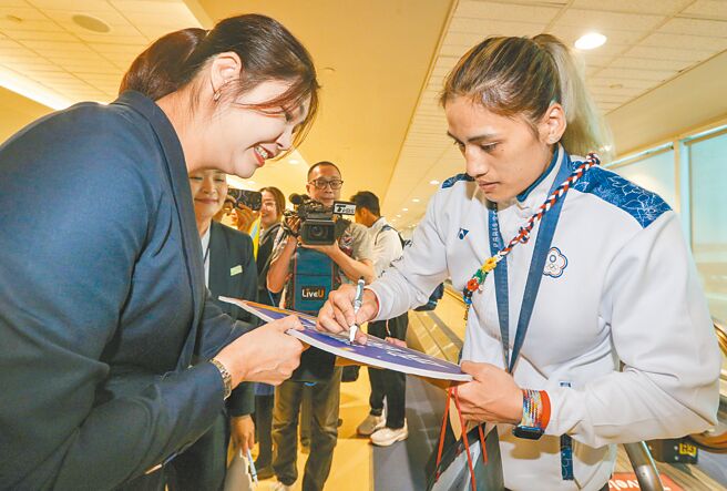 中華拳擊隊陳念琴（右）為前來接機的粉絲簽名。（陳麒全攝）