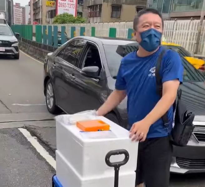 被卡在台1线接忠孝桥高架的男子，趁机做起生意。（翻摄爆废公社）