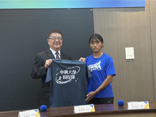 興大校長詹富智也贈送興大田徑隊的隊服以及球鞋給大學新生黃詩涵。（馮惠宜攝）