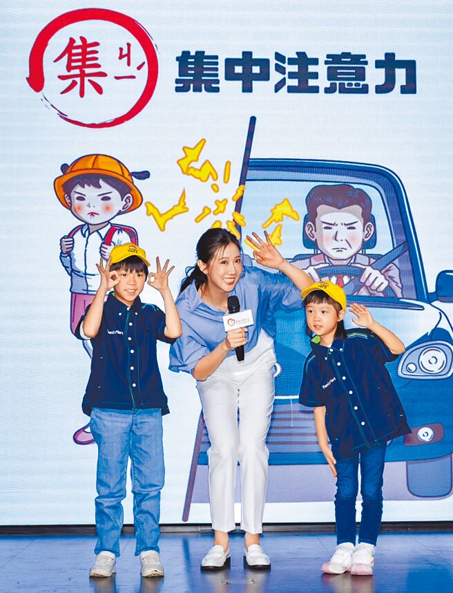 方志友（中）和小朋友一起示範交通安全撇步。（靖娟基金會提供）