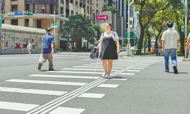 新北市近期针对市区重要路口增设「导盲行穿线」，辅以布榖鸟或蟋蟀声的有声号志，让视障朋友能更安全过马路。（柯毓庭摄）
