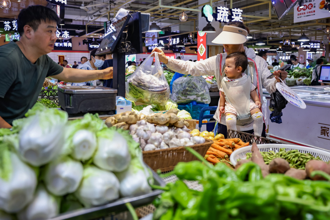 今年夏季大陸北方突如其來的暴雨淹沒農田，許多農作物幾近絕收，蔬菜產量大跌導致各地菜價飛漲。圖為江蘇南京太平農貿市場。（圖／新華社）