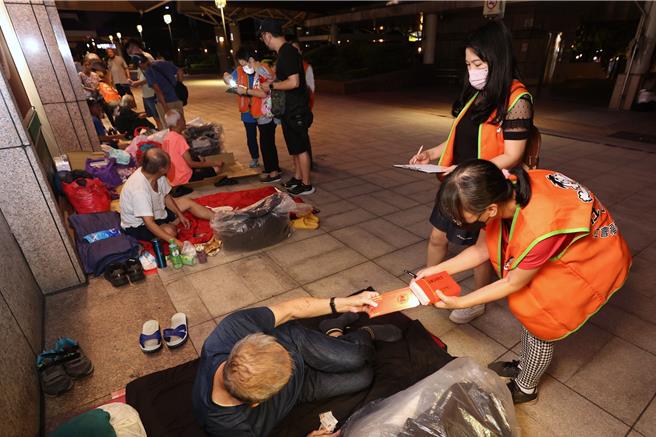 華人三大節日的中秋節將至，為溫暖孤獨無依的街友，仕招社會福利慈善事業基金會志工6日晚間至7日凌晨前往台北車站周邊關懷街友，並致贈中秋節禮金。（杜宜諳攝）