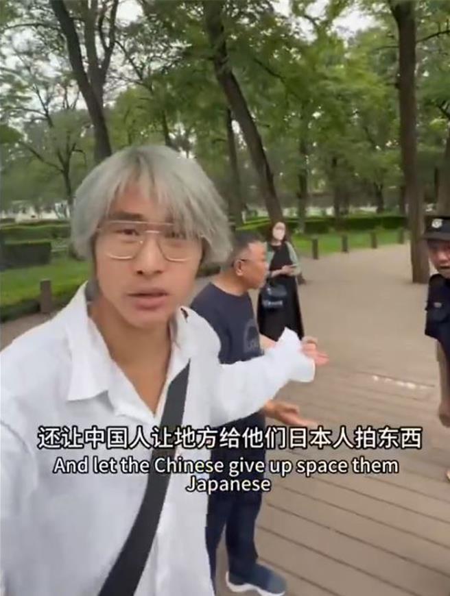 網紅（白衣男，前）不斷滋擾追拍導遊（中）和日本遊客（後），右為公園保安。（影音截圖）