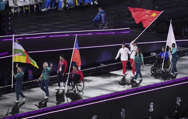 巴黎帕运会中国体育代表团旗手女子游泳运动员蒋裕燕（右5）和男子田径运动员邸东东（右4）在闭幕式上入场。（图／新华社）