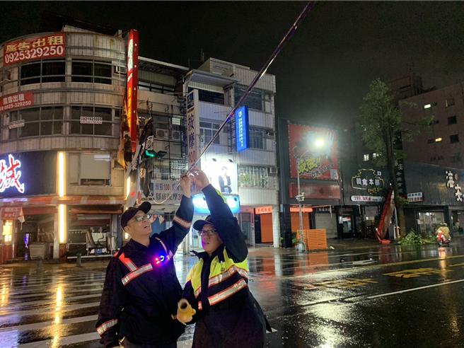 2名员警将电缆线撑住。（郭良杰摄）