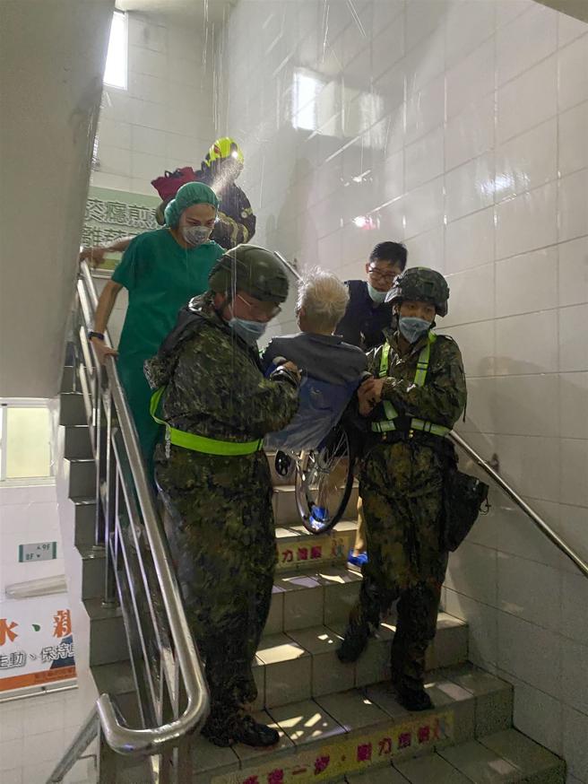 「山陀儿」颱风挟带强风豪雨造成各地出现灾情。屏东县东港镇安泰医院昨日发生火警，立即启动大量伤患机制，陆军机步333旅官兵配合医务人员，协助长者及病患向院外撤离。（第4作战区提供）