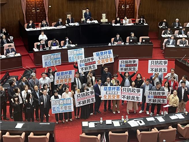 民進黨團在立法院議場內手持標語，高喊「只搞政爭不顧民生，惡意杯葛全民受害」。（游念育攝）