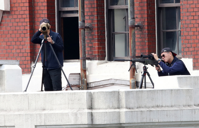 113年中華民國國慶大會10日盛大登場，總統府及凱道周邊的大樓頂有維安的狙擊手戒備，緊盯會場內狀況。（劉宗龍攝）