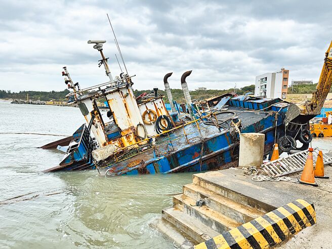 一艘停靠于金门復国墩渔港的200吨浚深工作平台，10月31日不敌康芮颱风与大浪的袭击，船首沉没、船尾翘起，情况岌岌可危。（于家麒摄）