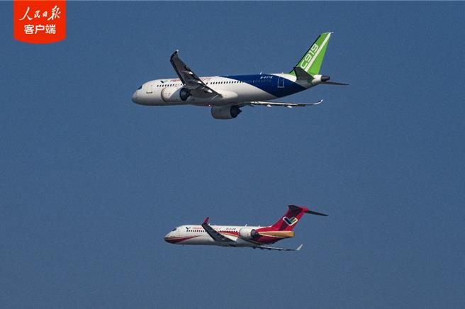陆国产ARJ21和C919客机首次双机编队飞行表演。（人民日报用户端）