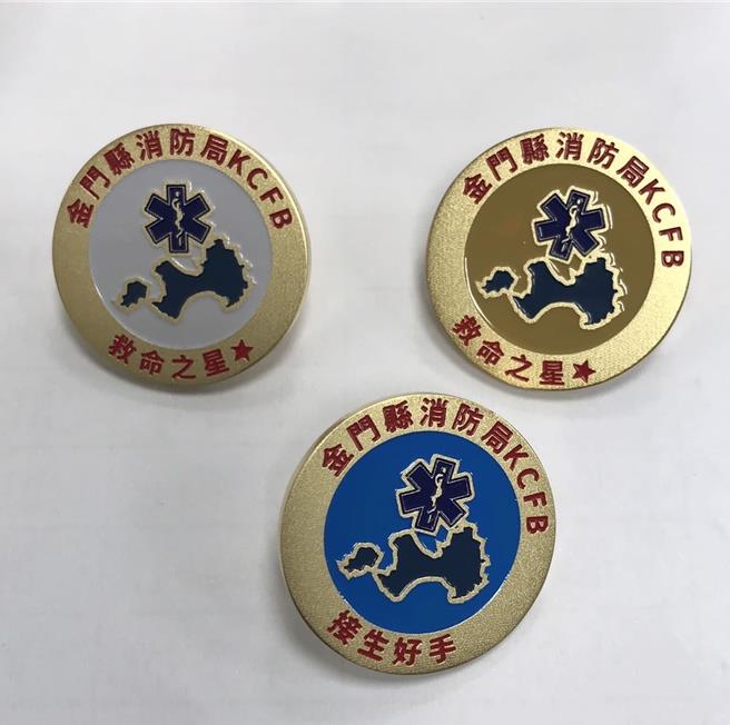 金门县消防局为表彰在到院前急救勤务中表现卓越之救护人员，全国首创设计二款荣誉胸章，其一款「救命之星」荣誉金章与银章，另一款荣誉胸章为「接生好手」蓝章。(图／金门县消防局提供)