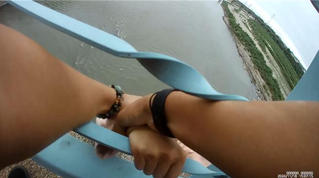 女子縱身跳下大肚溪之際，彰化警分局員警合力抓住女子，將她從鬼門關前救回。（警方提供／葉靜美彰化傳真）