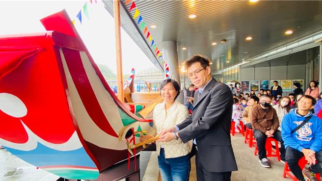 海洋委員會及國立海洋科技博物館耗時半年，以純手工打造，成功重現當年的木造八斗子罾子船。20日由海科館館長陳素芬（左）及海委會科長羅斯平（右）協力將船身釘上船眼，象徵船體完工落成。（海科館提供／徐佑昇基隆傳真）