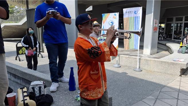 世界棒球錦標賽12強複賽，台南市22日的戶外直播湧現人潮，張姓民眾連兩天到場，還自帶樂器吹奏，帶動現場氣氛。（程炳璋攝）