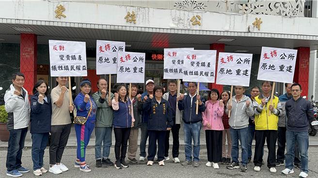 罗东镇长吴秋龄（中）与多名里长至镇公所前广场，高举「支持公所原地重建」、「反对变卖镇产，牺牲镇民权益」的牌子并喊口号，以表达立场。（吴佩蓉摄）