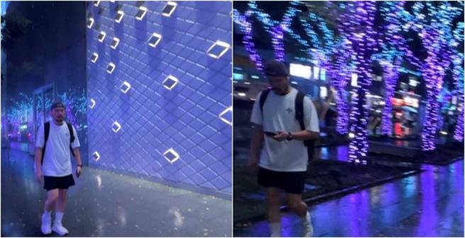 李銘忠深夜頂著小雨走在信義區街道上。（圖／讀者提供）