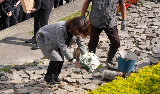 何琇琼为琼瑶花葬之处献上一束花。（图／中时资料照）