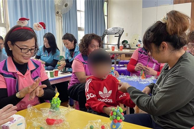 屏東鳳凰扶輪社社長洪明麗（左一）和伊甸慢飛天使一起手作聖誕樹。（伊甸基金會提供／羅琦文屏東傳真）